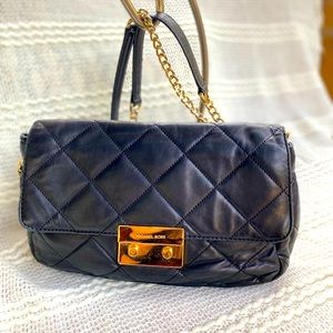 Micheal kors Black /gold medium size convertible bag.